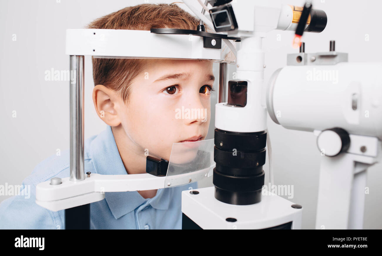 Caucasian boy receiving eye exam at clinic, eyesight examination children Stock Photo Alamy