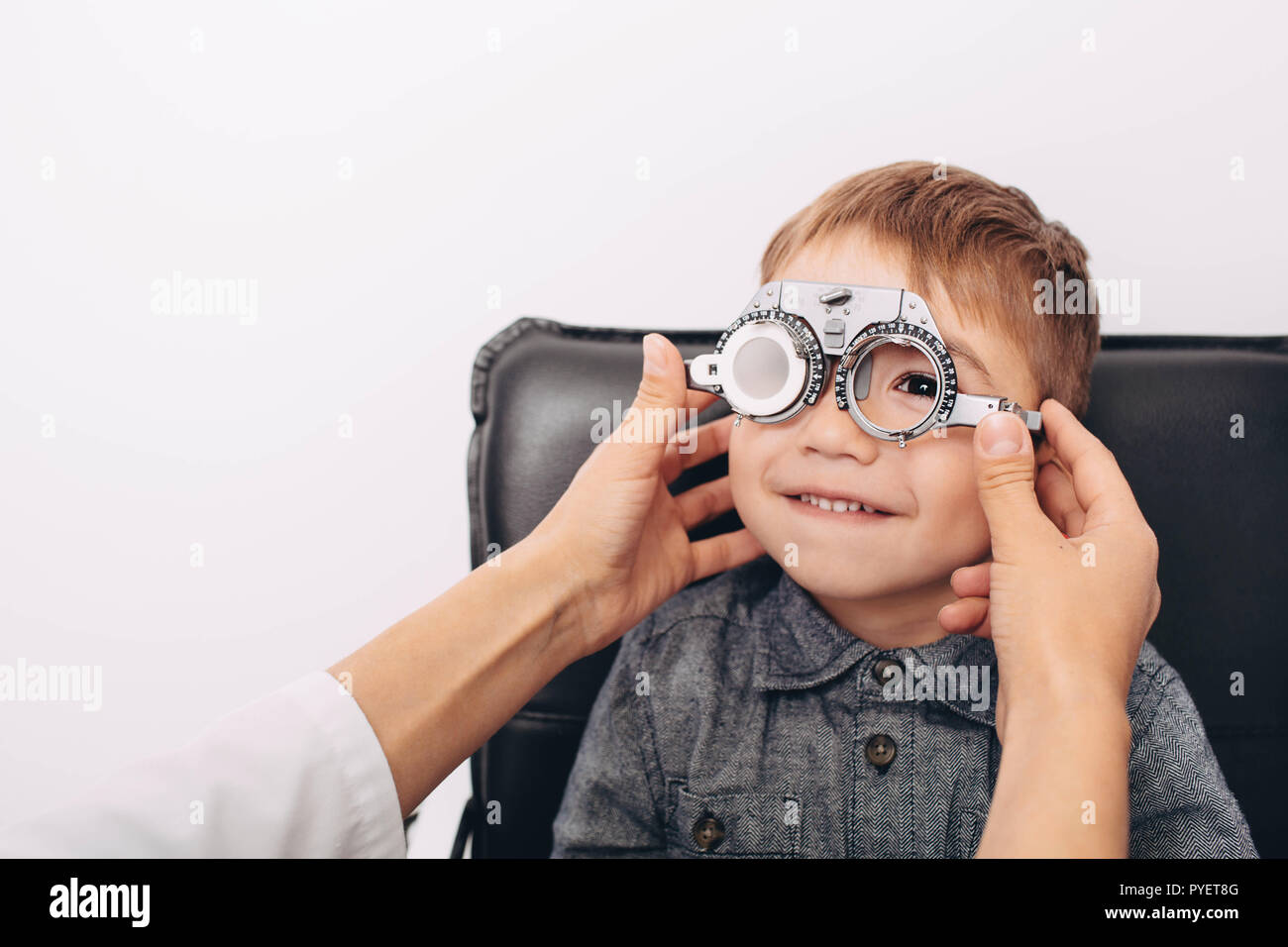 little boy, having his eye exam with trial frame Stock Photo