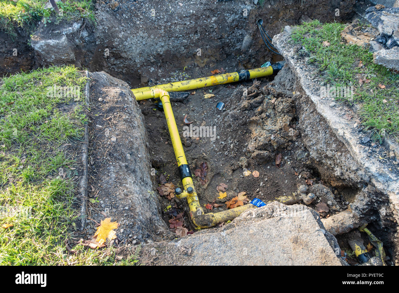 Large trenches dug in the ground to replace pipework as part of maintenance works. Stock Photo