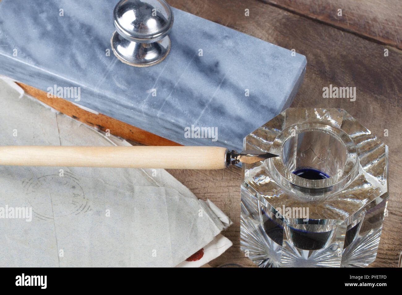 Inkwell Quill pen and glass inkwell with old letters on a wooden desk Stock ...