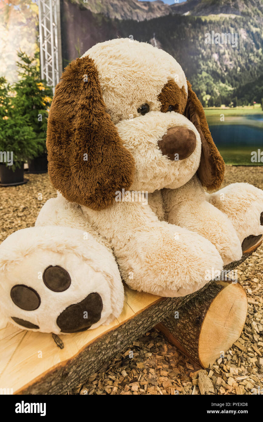 sad big stuffed white dog doll on a wooden bench, switzerland Stock Photo -  Alamy