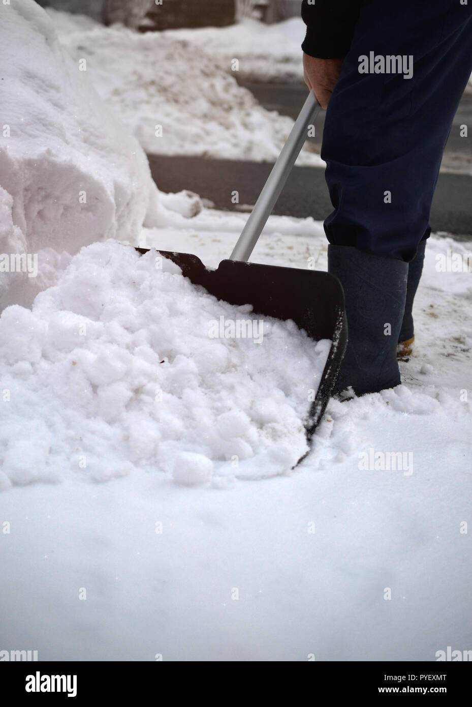 snow man shovel push sweep skipper clearing Stock Photo