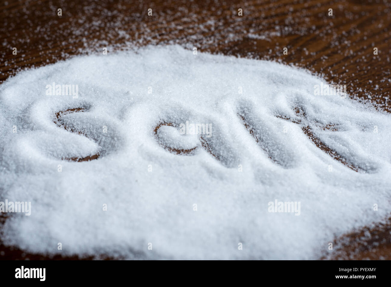 salt on wooden background, writing Stock Photo