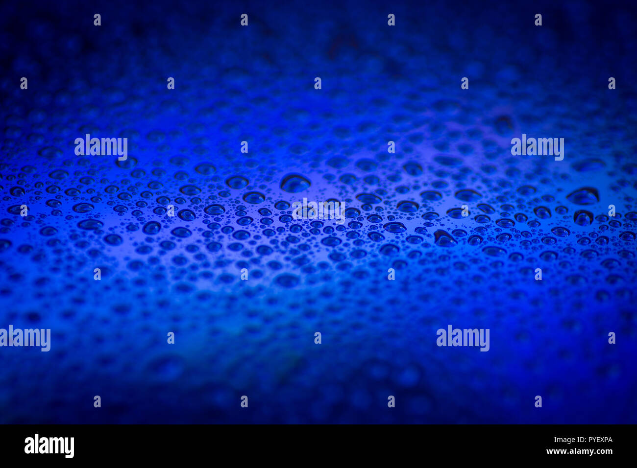 Cloys up to water drops on glass background with color light Stock Photo