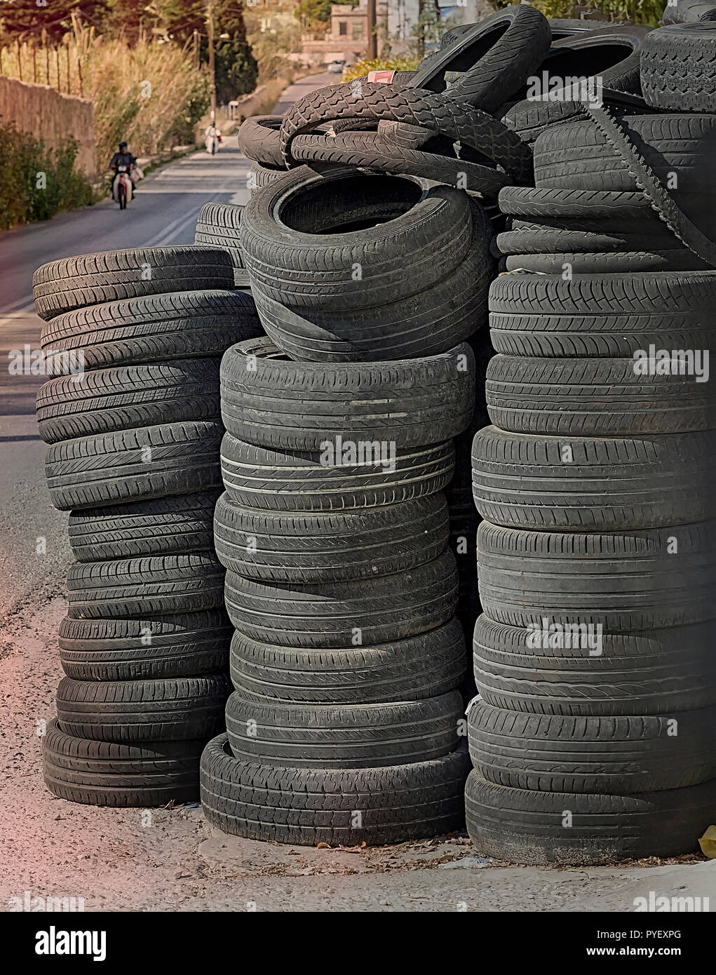 A pile of car tyres outside  a  service garage . Stock Image. Stock Photo