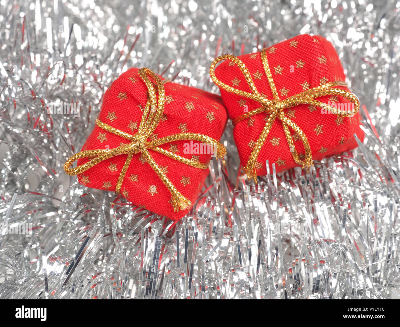 Two red Christmas gift boxes with shiny silver decoration Stock Photo