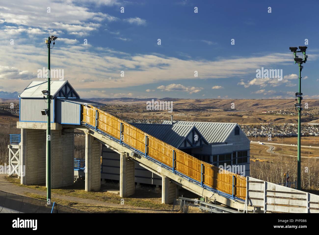 Bob Sleigh Winter Sport Facility COP Canada Olympic Park.  Distant Prairie Rocky Mountain Foothills Landscape.  City of Calgary Alberta Blue Skyline Stock Photo