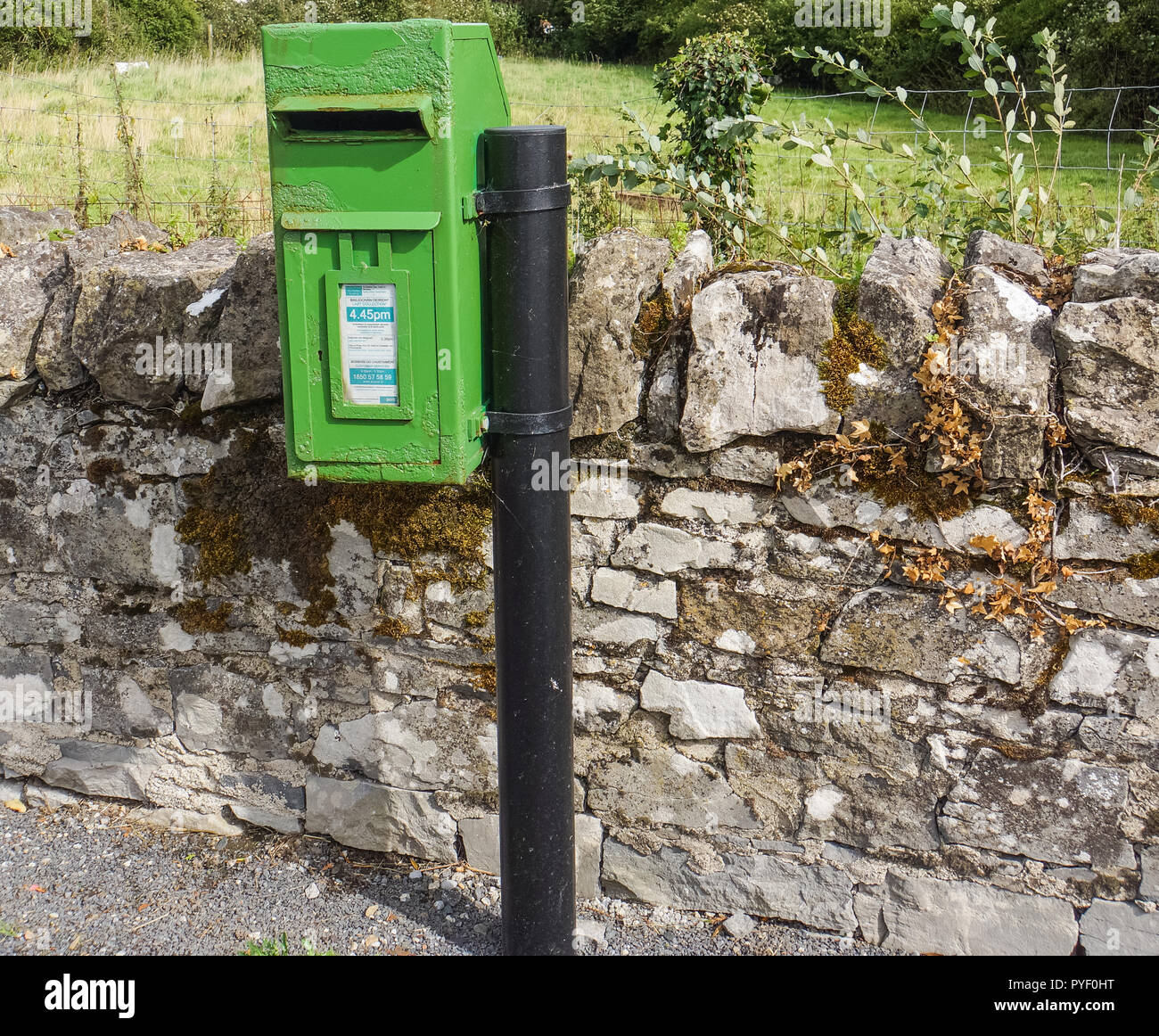 bright green rural post office mail box  on Irish country road Stock Photo