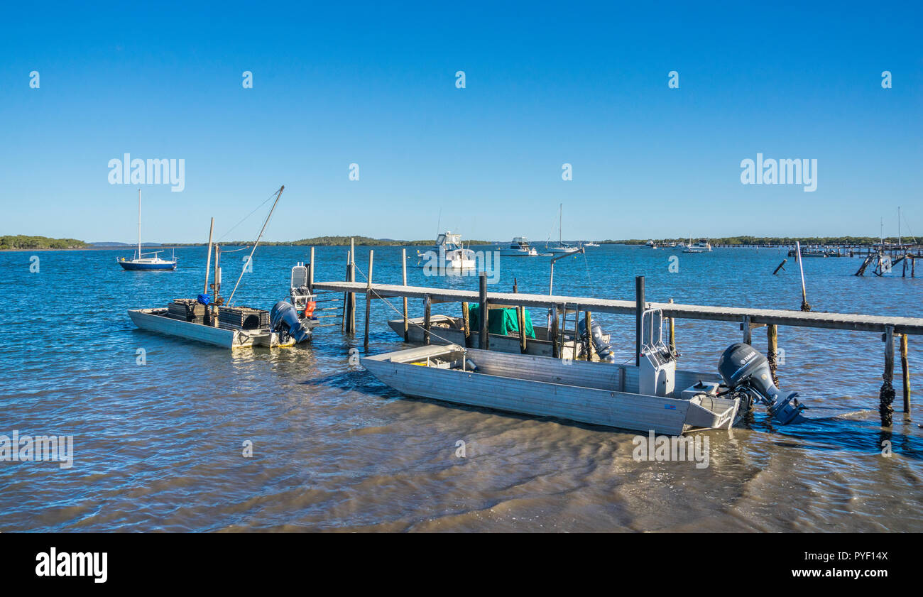 Flat bottomed oysterboats moored at the Karuah River waterfront at