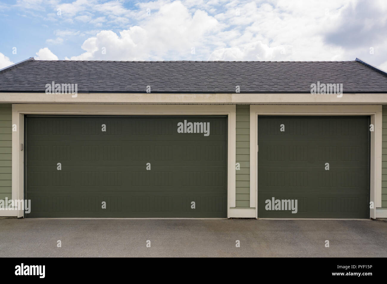 Three Car Garage With Wide Double Door On Cloudy Sky