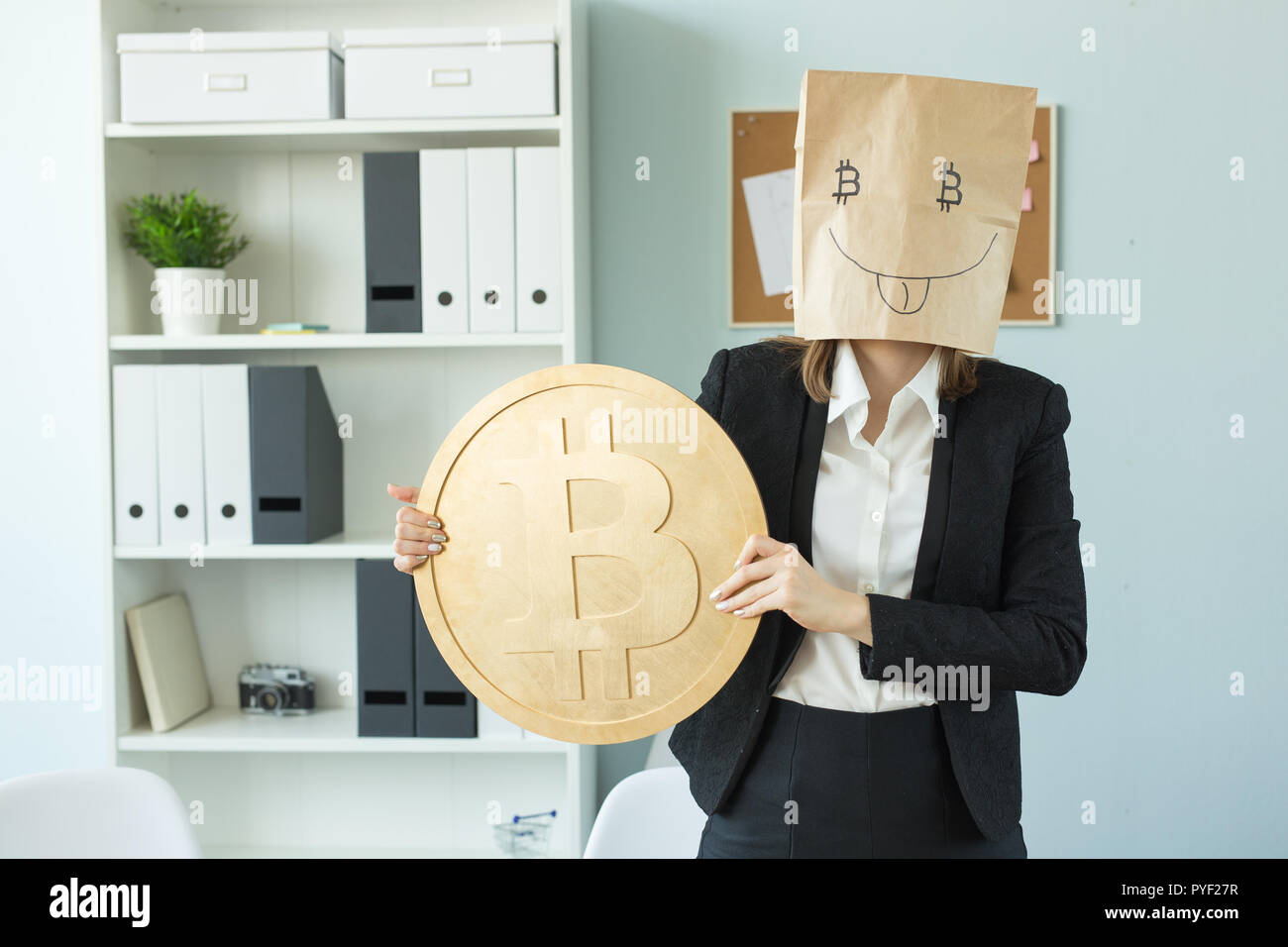 Crypto currency, money, blockchain concept - funny woman with package on  her head show us a huge bitcoin. She looks like crazy Stock Photo - Alamy