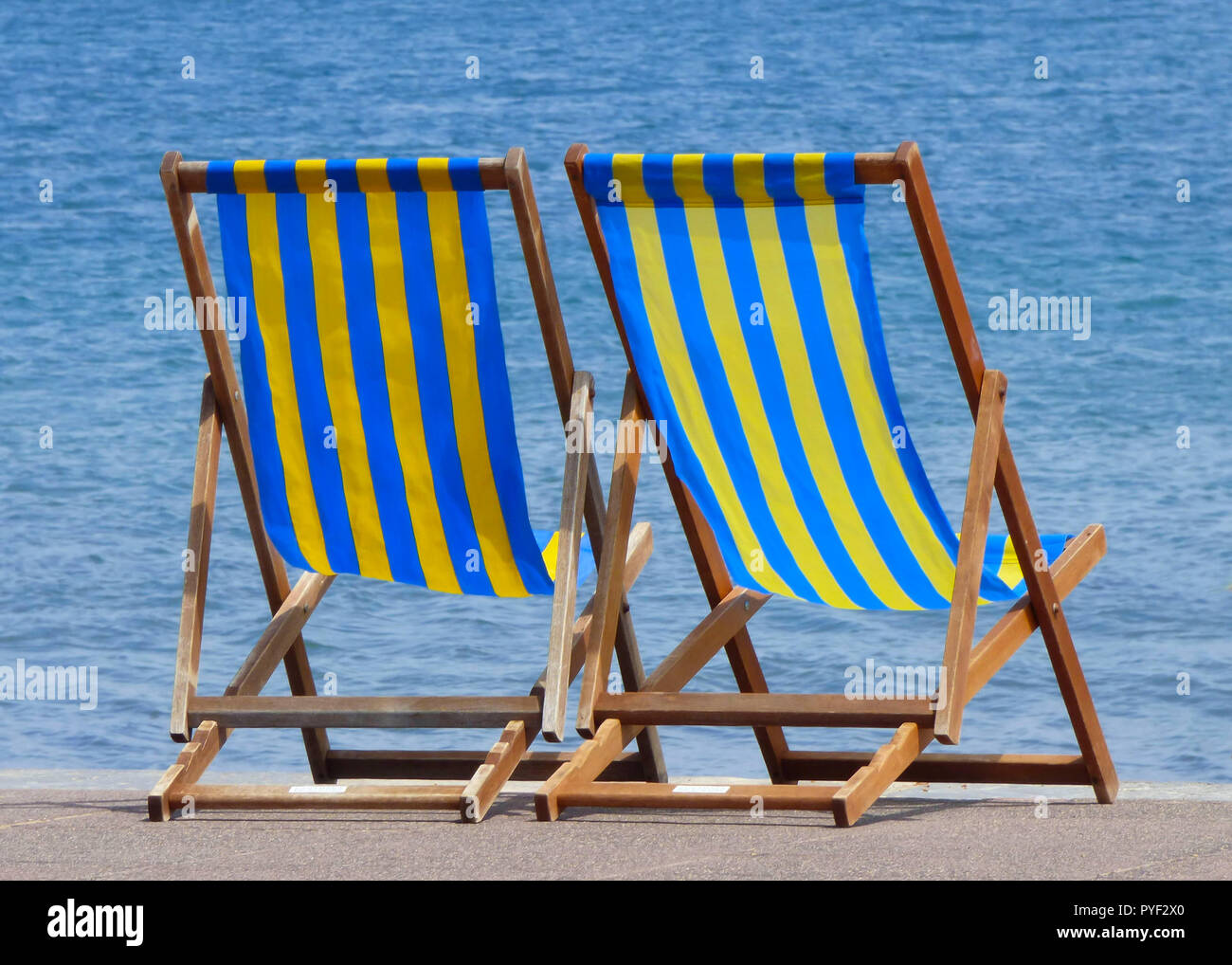 Blue and yellow striped deck chairs on a beach at Bournemouth