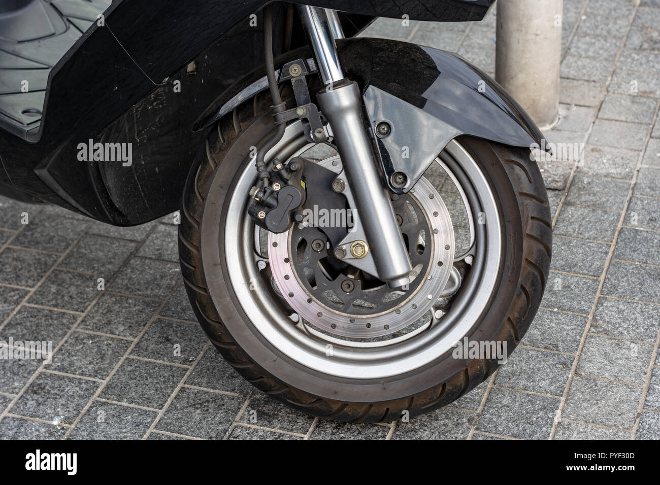 the front wheel of the moped. disc brakes. outdoor Stock Photo Alamy