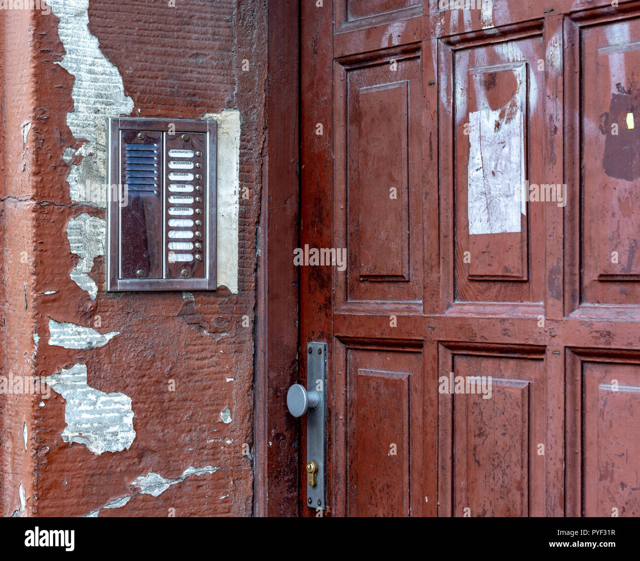 the old door of the House. intercom on the old wall. day Stock Photo