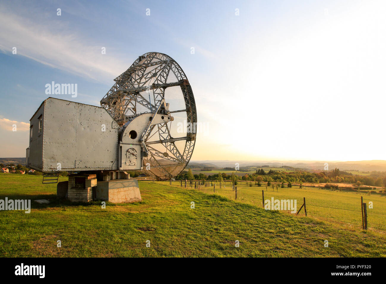 Satellite dish in a summer landscape, sky background. Stock Photo