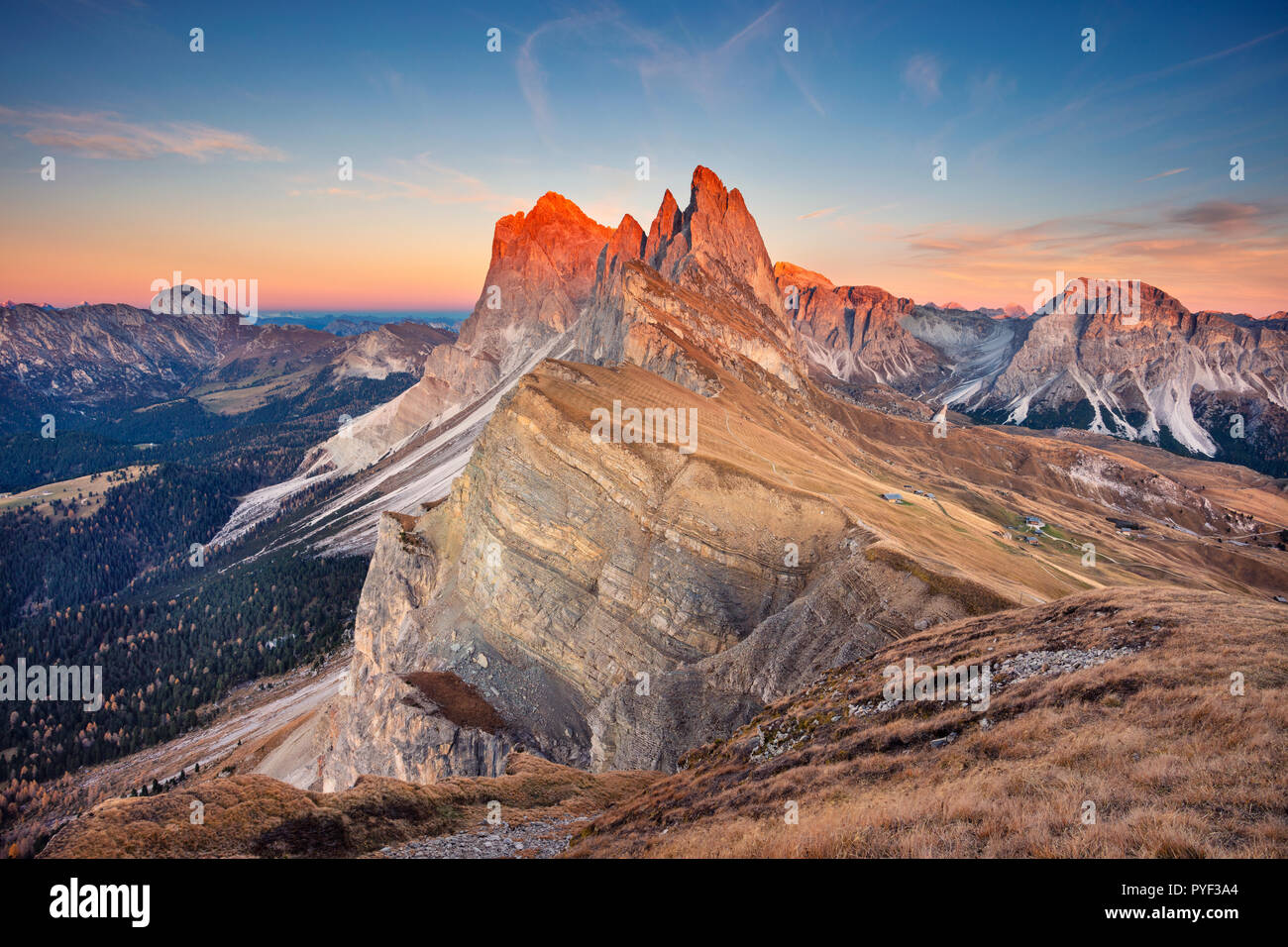 Dolomites. Landscape image of famous Dolomites mountain peaks glowing in beautiful golden evening light at sunset in autumn, South Tyrol, Italy. Stock Photo