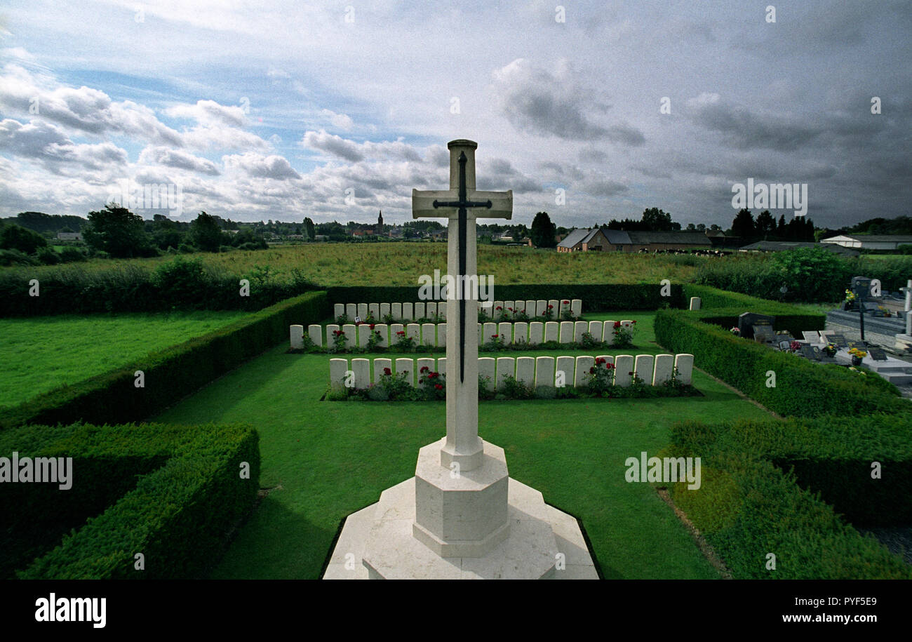 Wilfred Owen the poet died on 4th November 1918 just 7 days before the end of the first world war. A photograph of Owen normally rests against his grave at Ors Communal Cemetery  in the Commonwealth WarGraves Commission plot. The town of Ors is a commune in the Nord department in northern France can be seen in the background and the spot where Owen died is just behind the Church spire in the background of this photograph. Owen was killed in action on 4 November 1918 during the crossing of the Sambre–Oise Canal, exactly one week (almost to the hour) before the signing of the Armistice which end Stock Photo