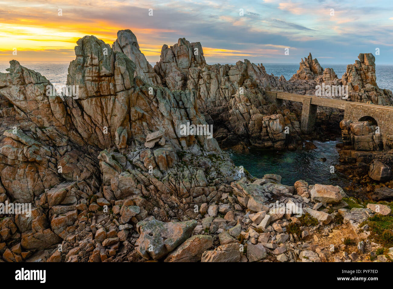 The sharp rocky coastline of Ushant island at sunset, Brittany, France Stock Photo