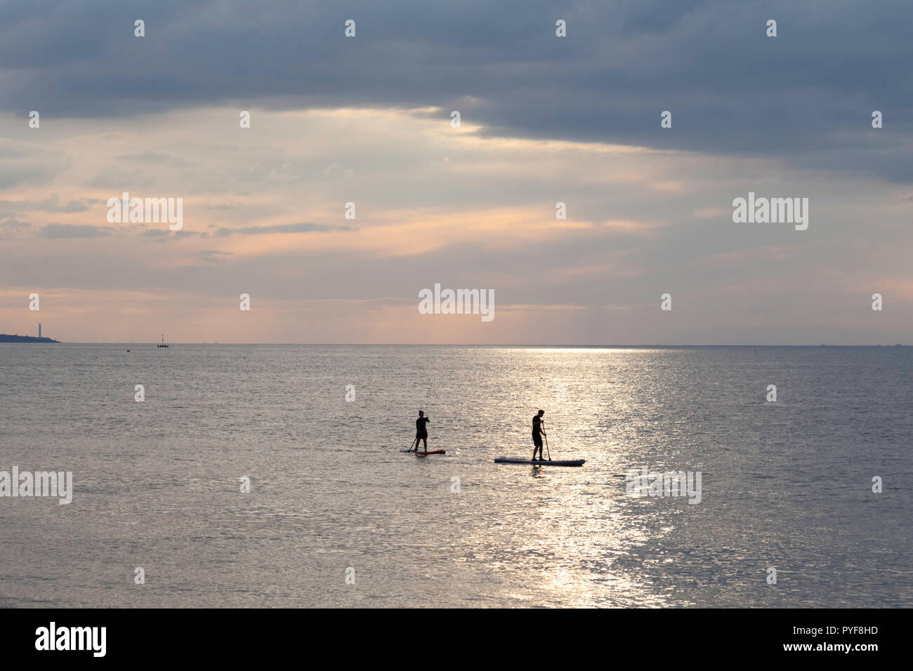 Two paddleboarders off the coast of Herne Bay, Kent, UK. Stock Photo