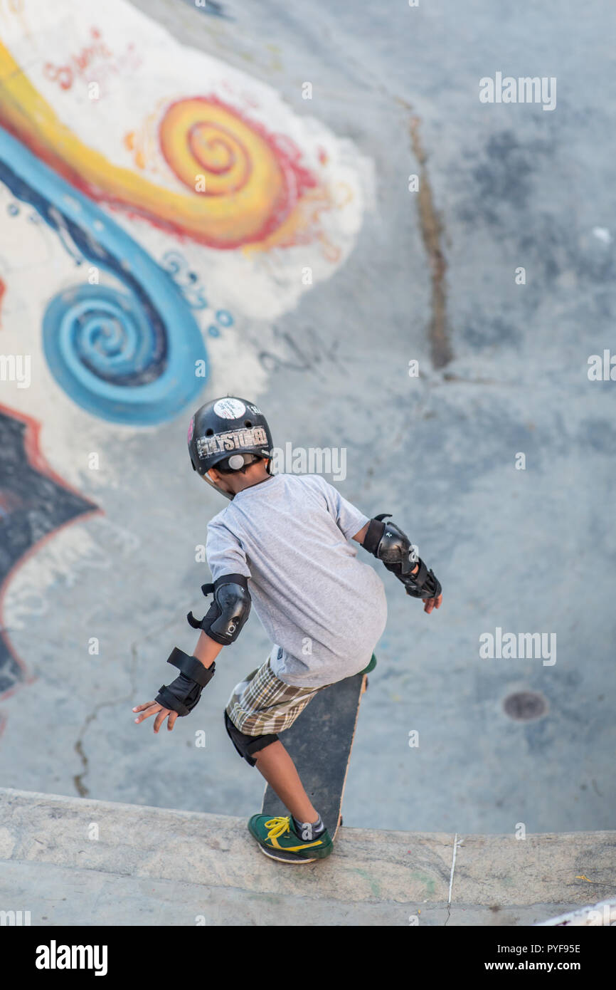 Kid preparing to go down a skateboard ramp Stock Photo