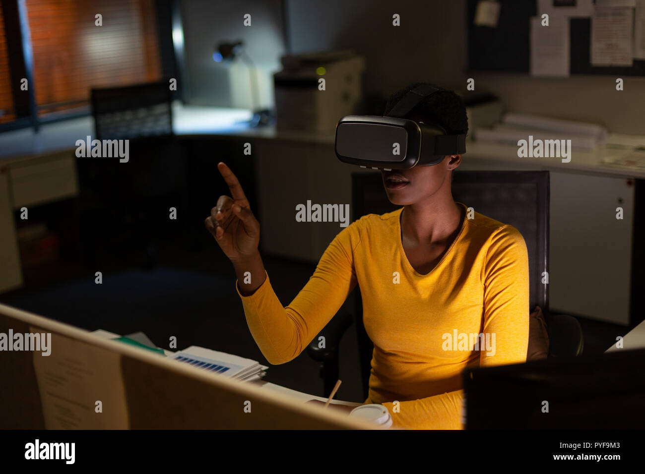 Female executive using virtual reality headset Stock Photo