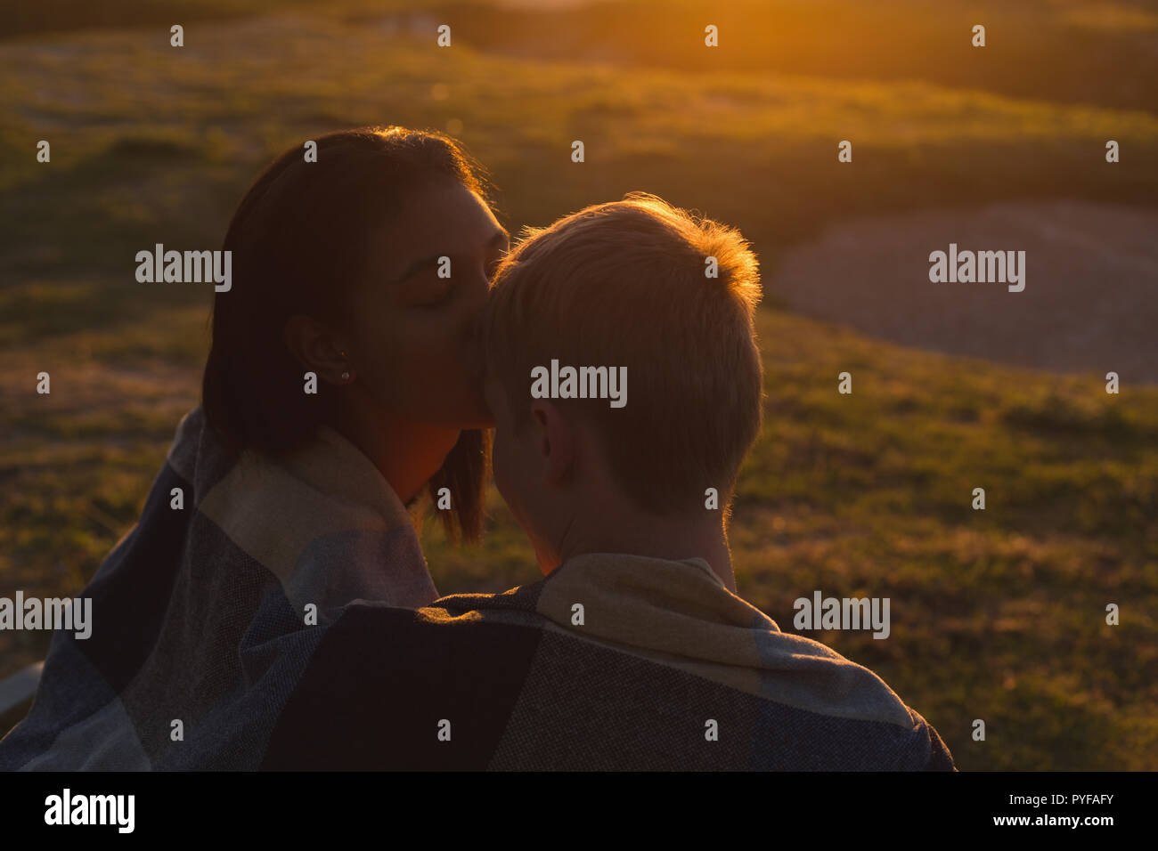 Couple kissing on beach Stock Photo