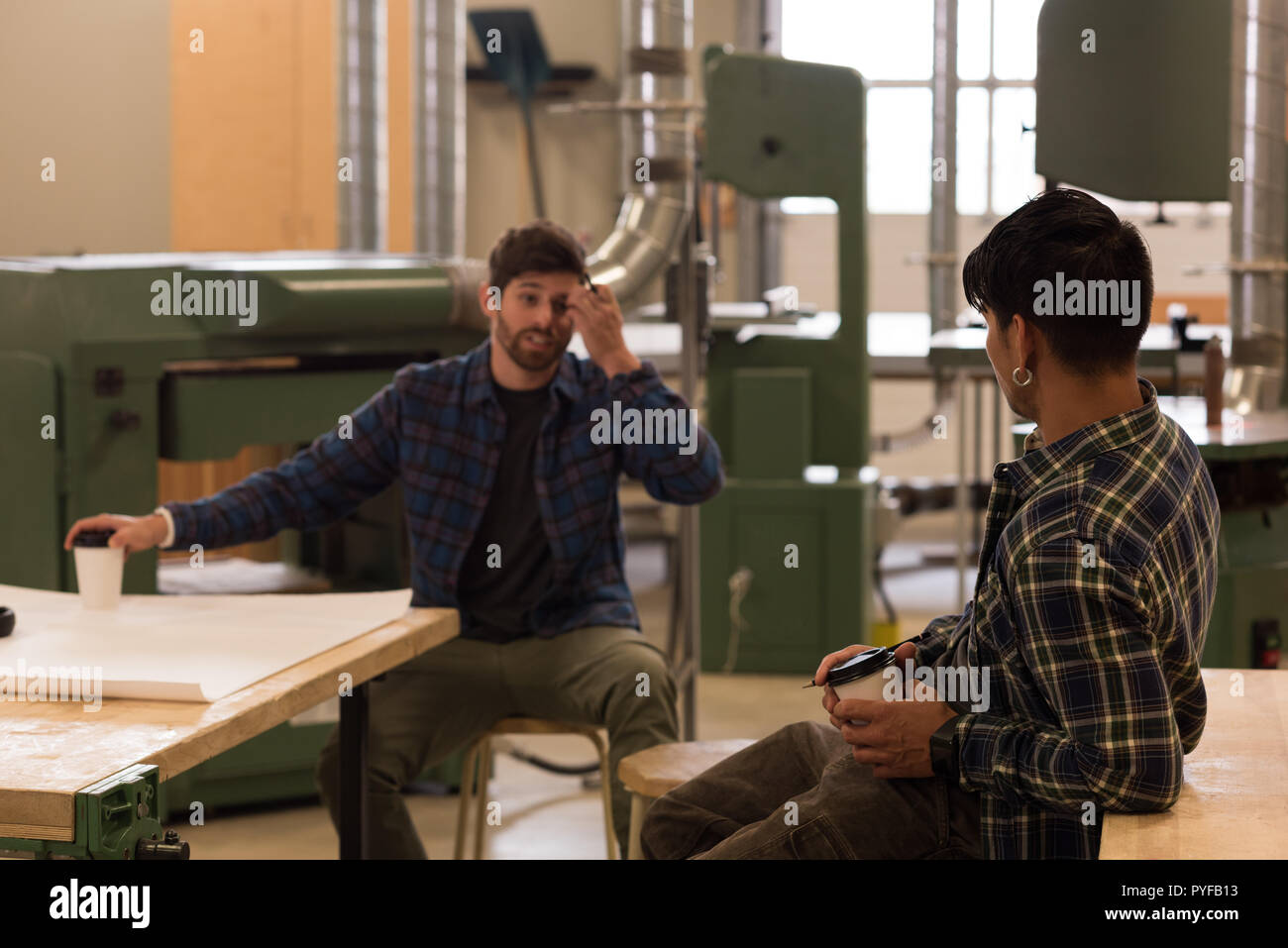 Two craftsman interacting with each other Stock Photo