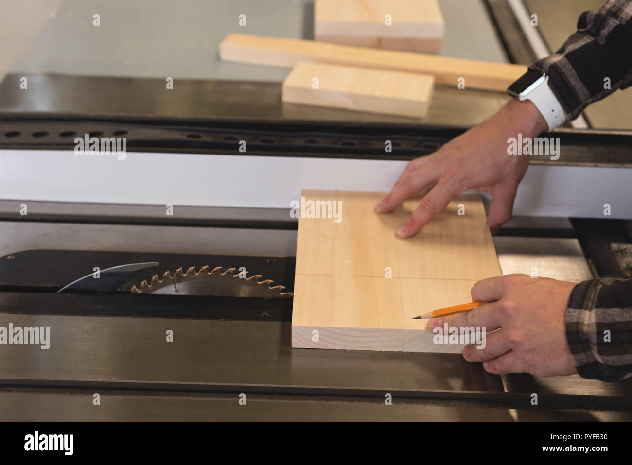 Craftsman measuring wooden plank in Stock Photo Alamy