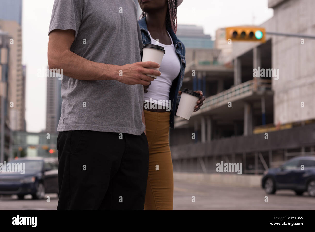 Couple with coffee cup walking on the street Stock Photo