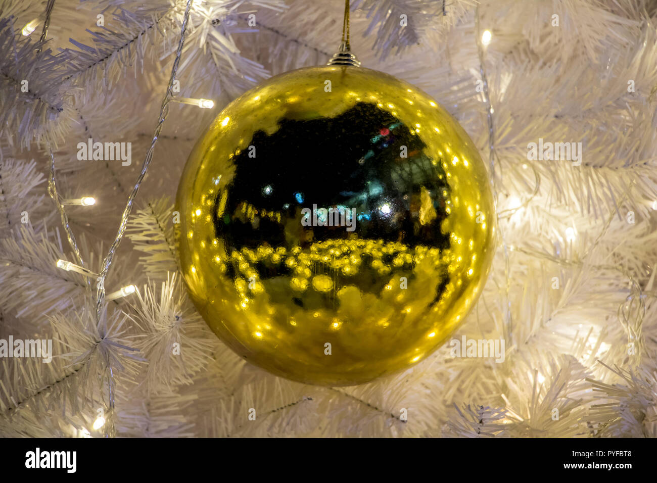 Decorative Golden Balls Hanging On A Christmas Tree With A White