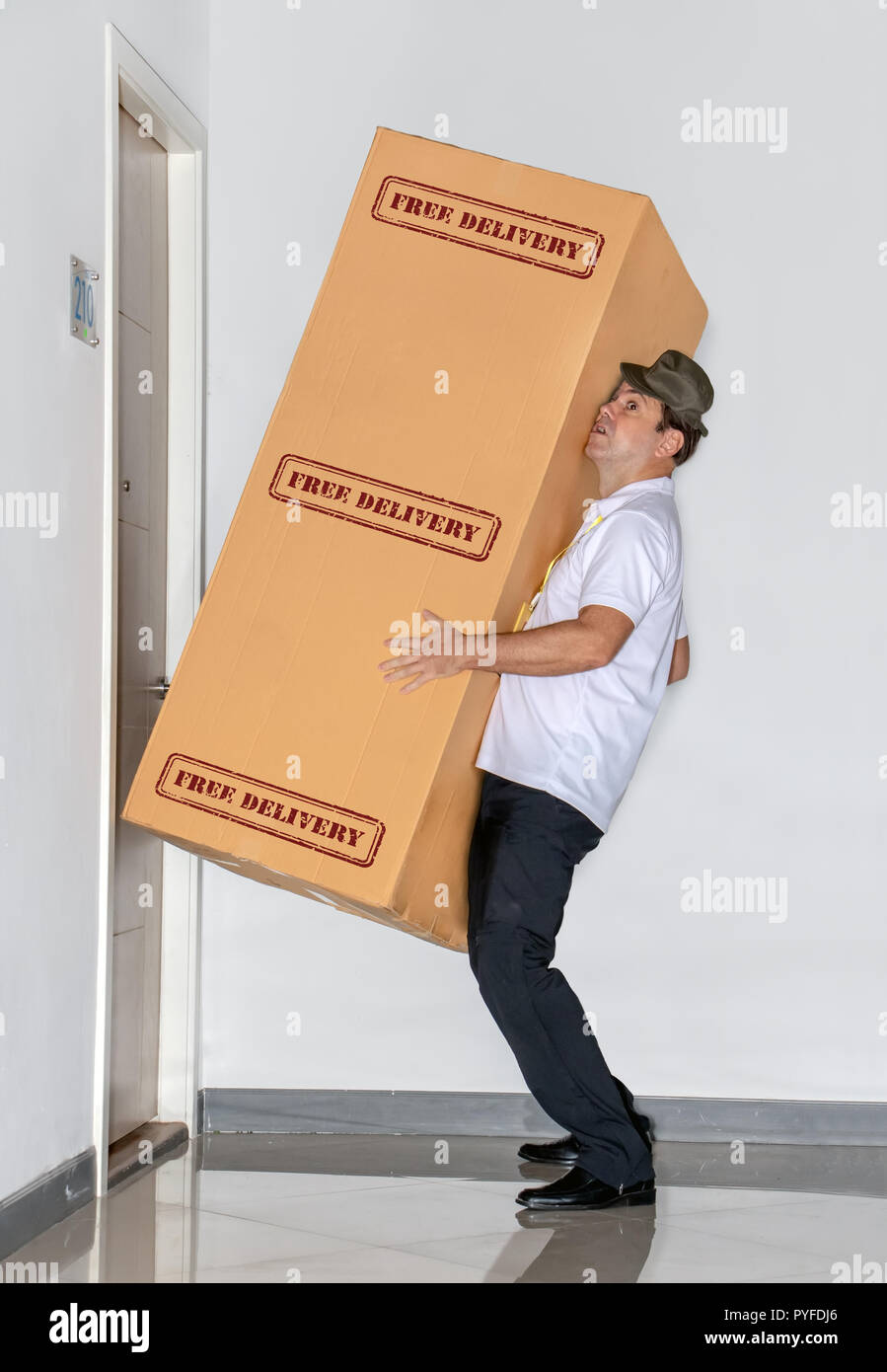 The postman carries a big package free delivery. The mail service