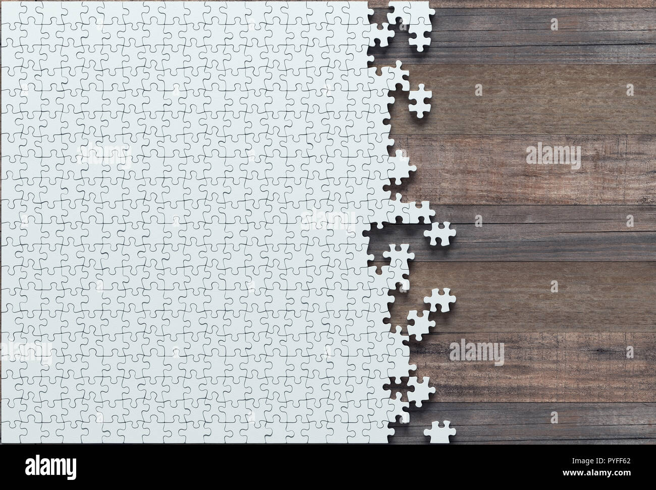 Blank jigsaw puzzle missing half to finish. Concept of work not completed. Stock Photo