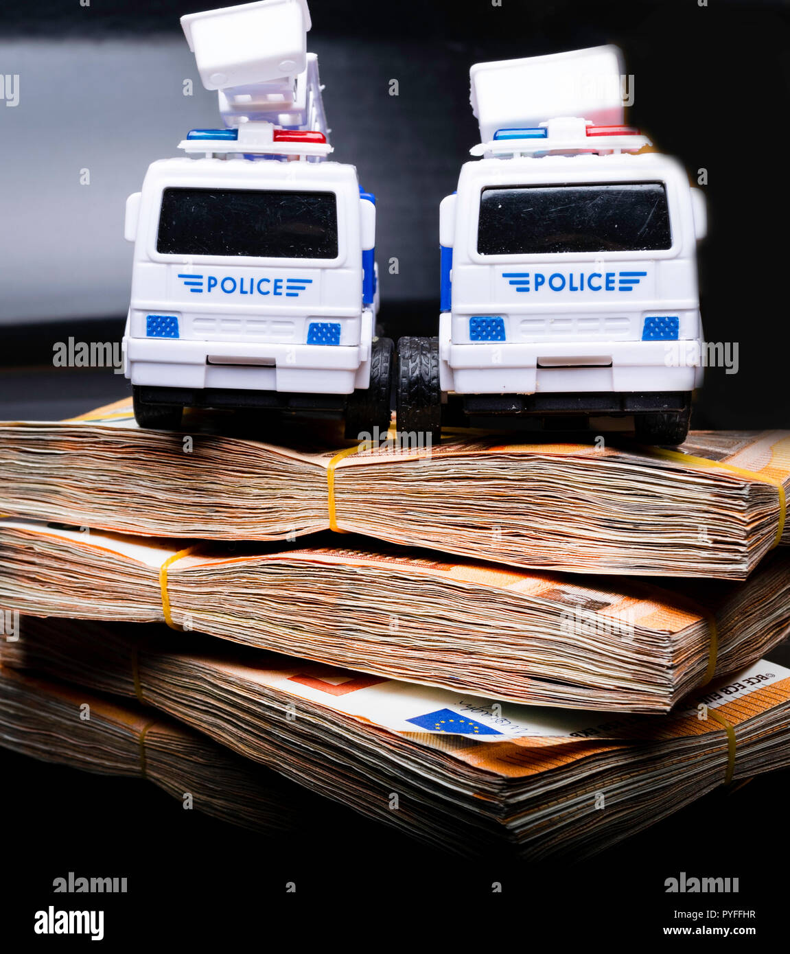 Police corruption in money. Police cars in euros. Crisis in money, bribe and corruption concept Stock Photo