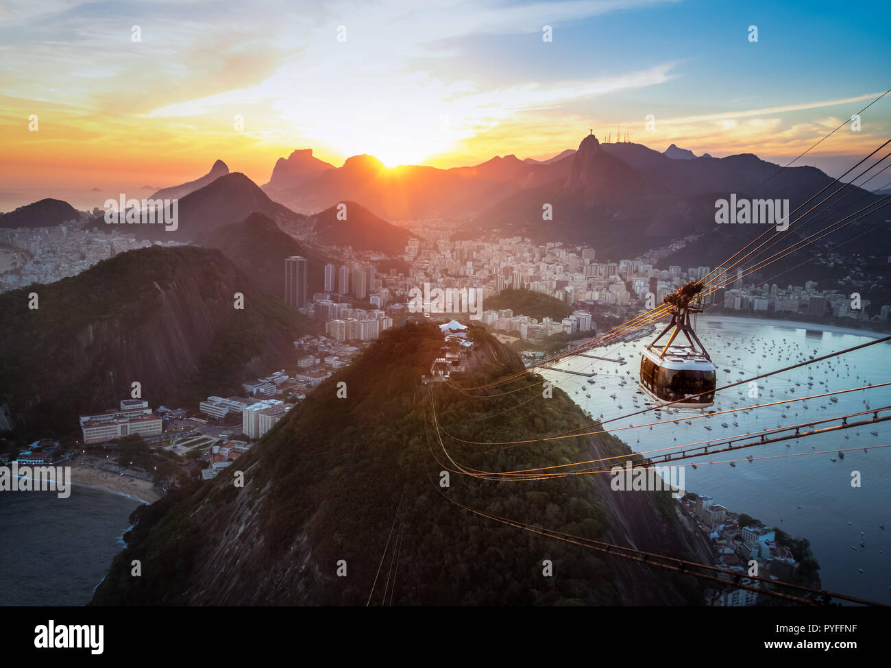 Aerial view of Rio de Janeiro at sunset with Urca and Sugar Loaf Cable Car and Corcovado mountain  - Rio de Janeiro, Brazil Stock Photo