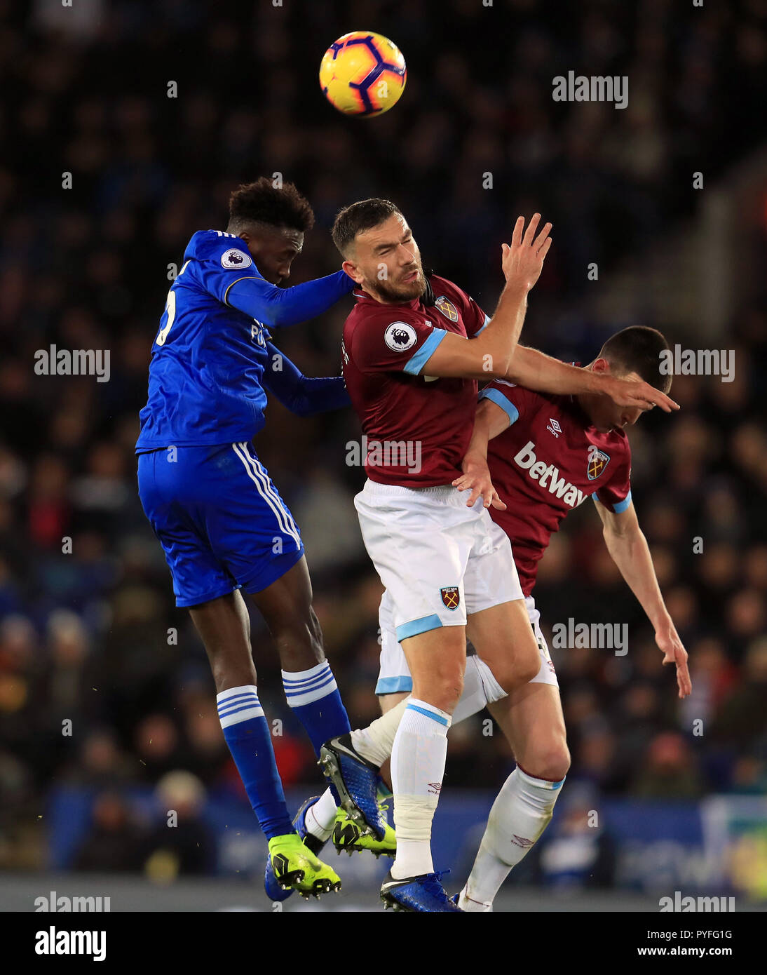 Leicester City's Wilfred Ndidi (left) and West Ham United's Robert Snodgrass battle for the ball in the air during the Premier League match at The King Power Stadium, Leicester. Stock Photo