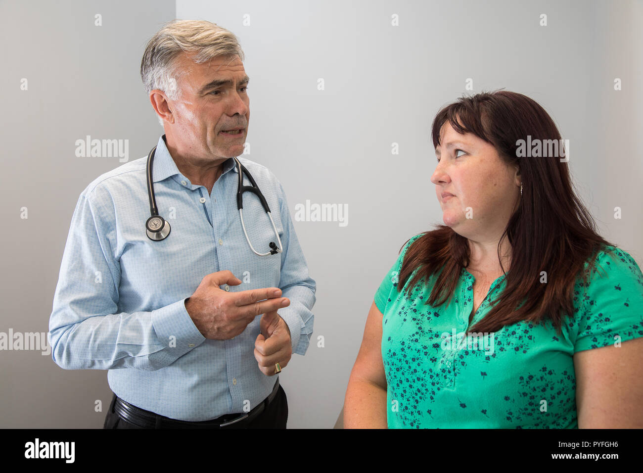 Doctor examines patient with stethoscope Stock Photo - Alamy