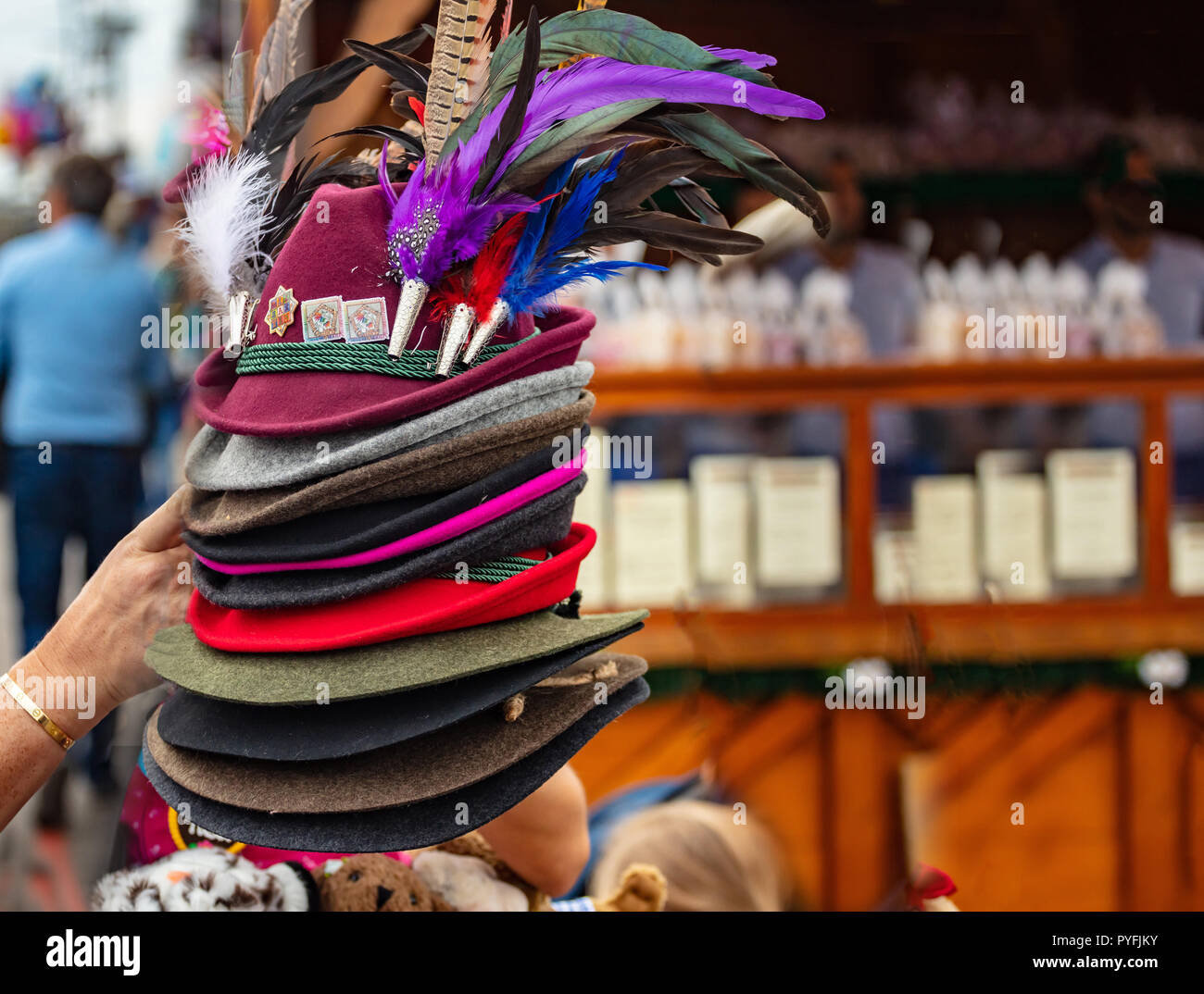 Stack of traditional tyrolean hats with feathers, Oktoberfest, Munich, Bavaria Stock Photo