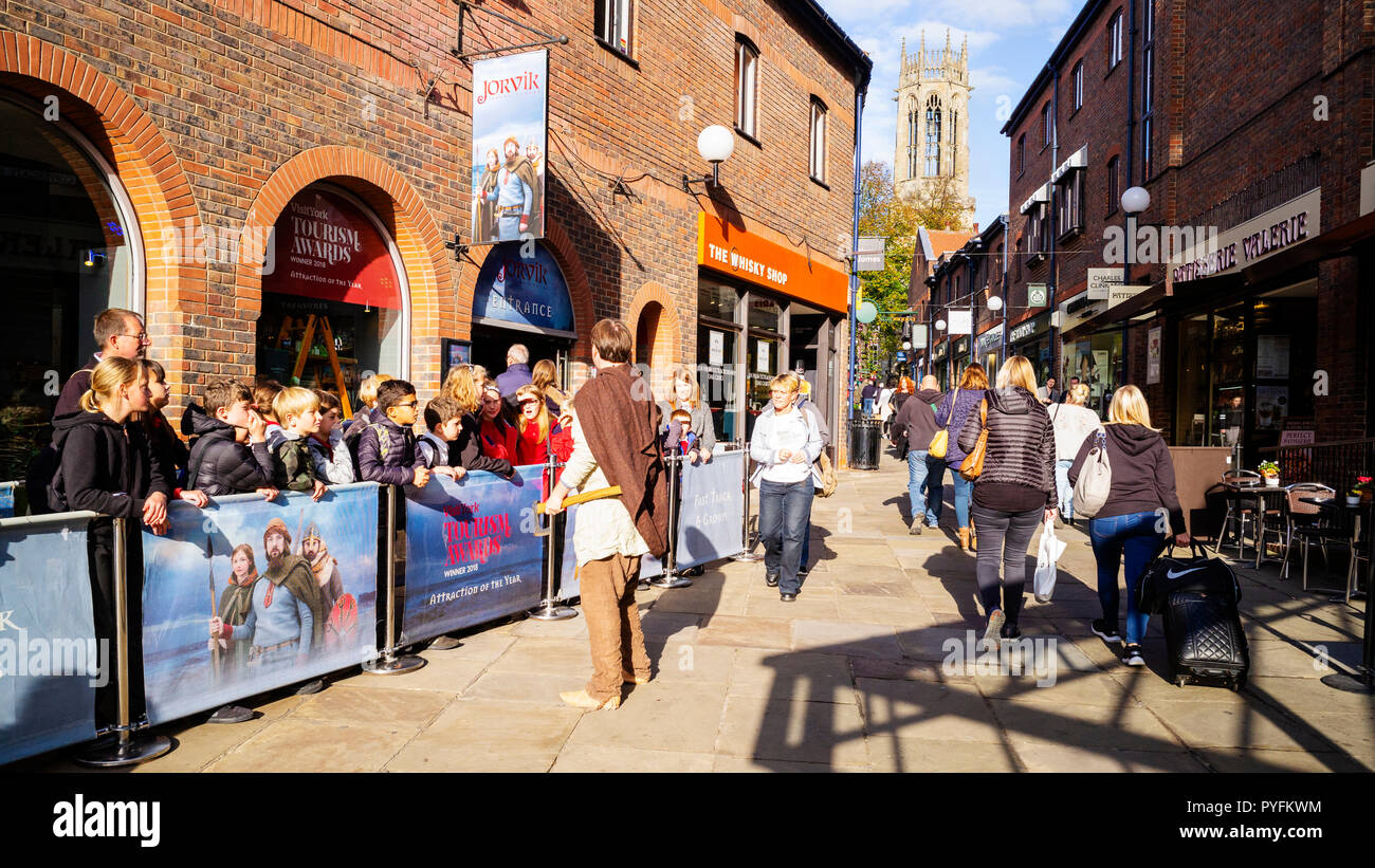Children attending to a Guide while waiting for admission to the Jorvik Viking Centre, Coppergate, York, UK Stock Photo