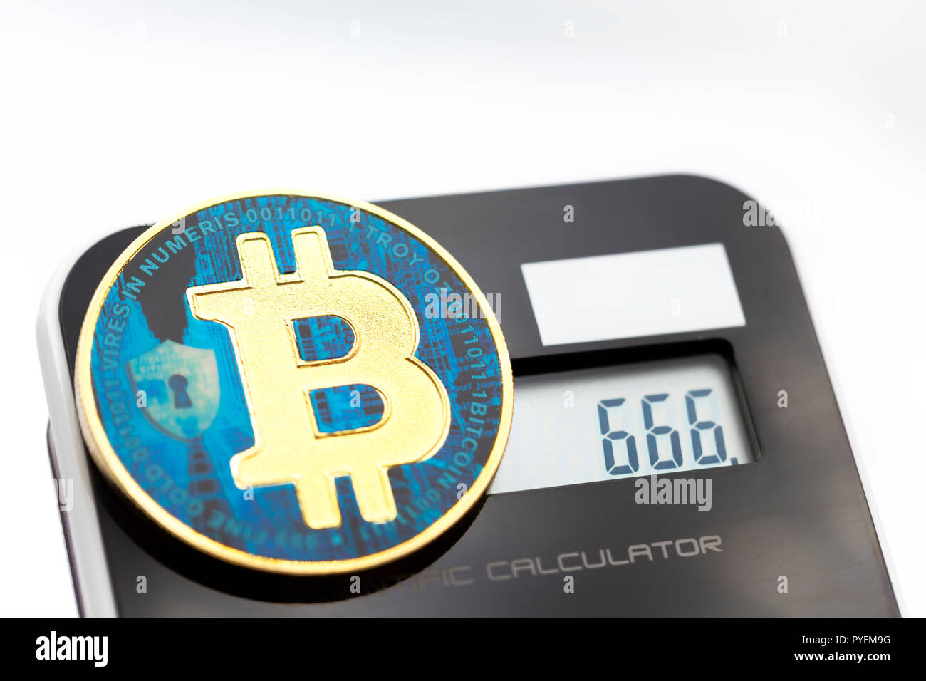 near a calculator the coin of bitcoin like concept of future and investment  666 in the display Stock Photo - Alamy