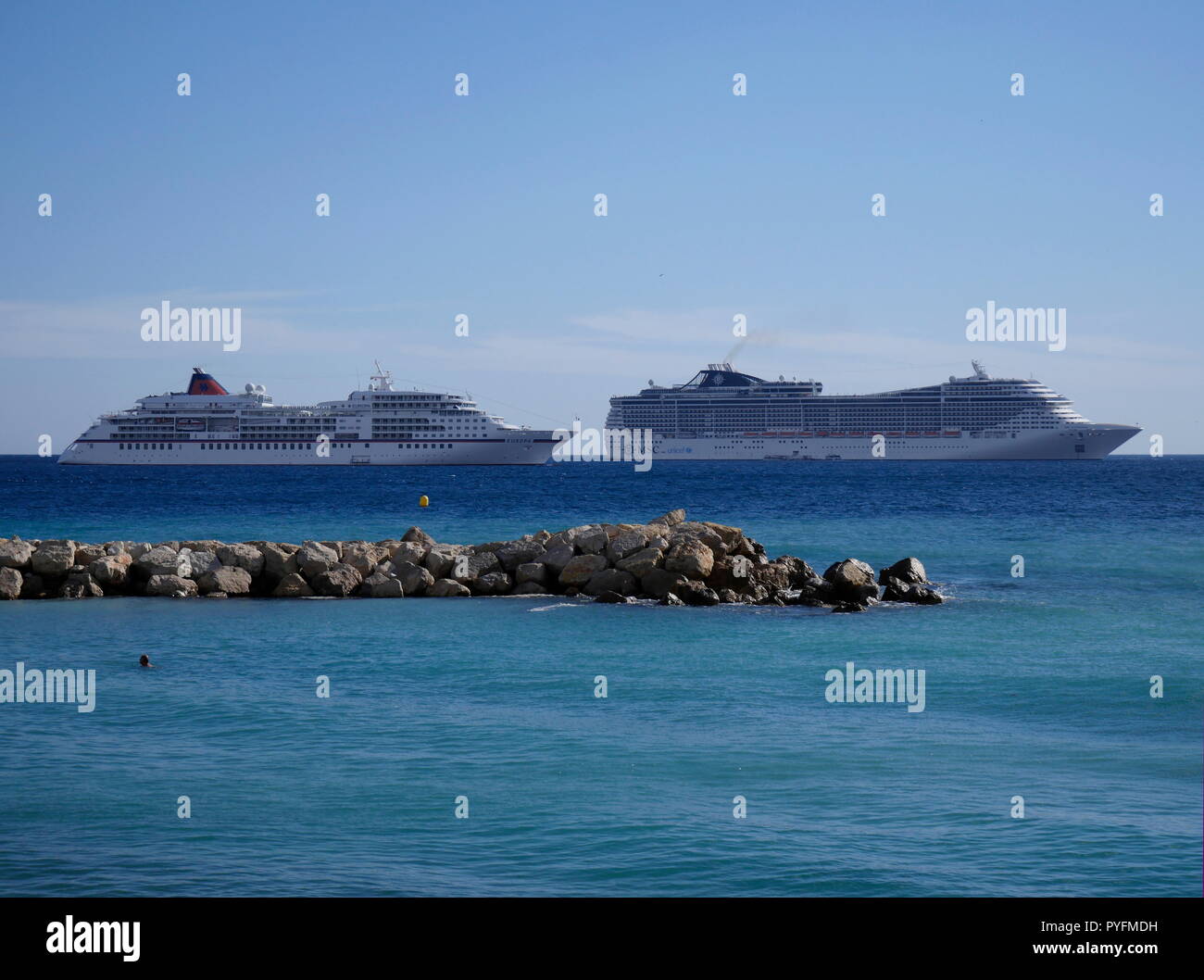 AJAXNETPHOTO. 2018. CANNES, FRANCE. - COTE D'AZUR RESORT - THE HAPAG LLOYD CRUISE LINER EUROPA (L) AND MSC FANTASIA ANCHORED IN THE BAY. PHOTO:JONATHAN EASTLAND/AJAX REF:GX8 180310 770 Stock Photo