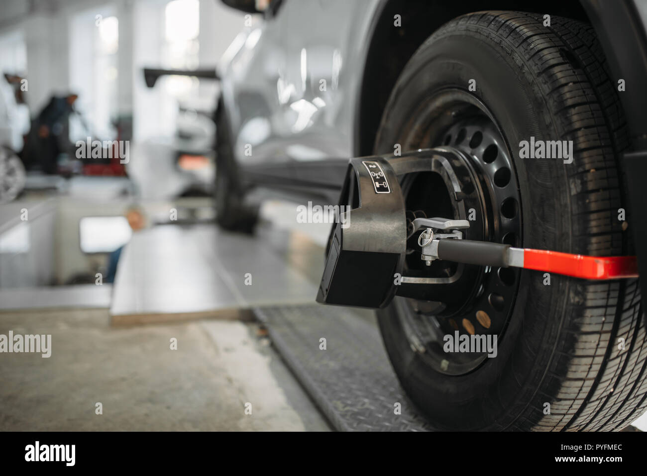 Car on collapse of convergence stand in autoservice. Computer