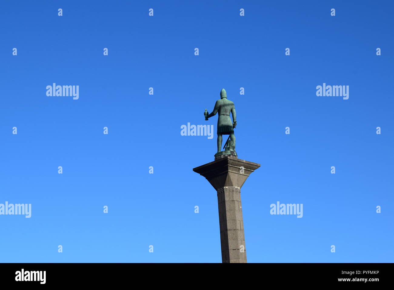 Statue of Olav Tryggvason located in exact city center, Trondheim, Norway stands against the blue sky. Stock Photo