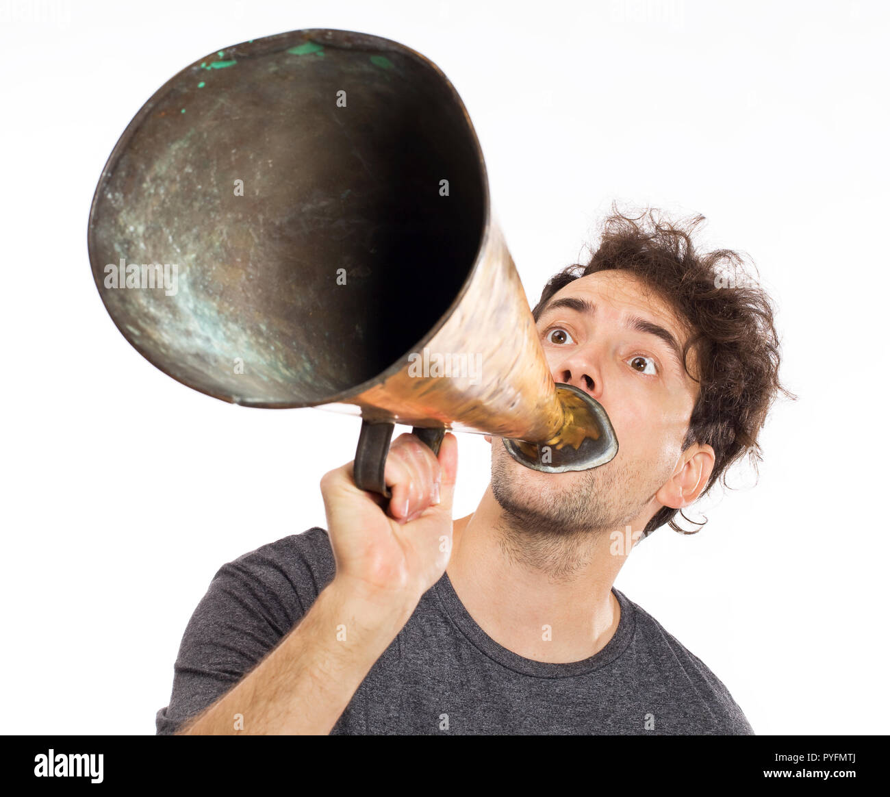 Young man yelling into a retro megaphone Stock Photo Alamy