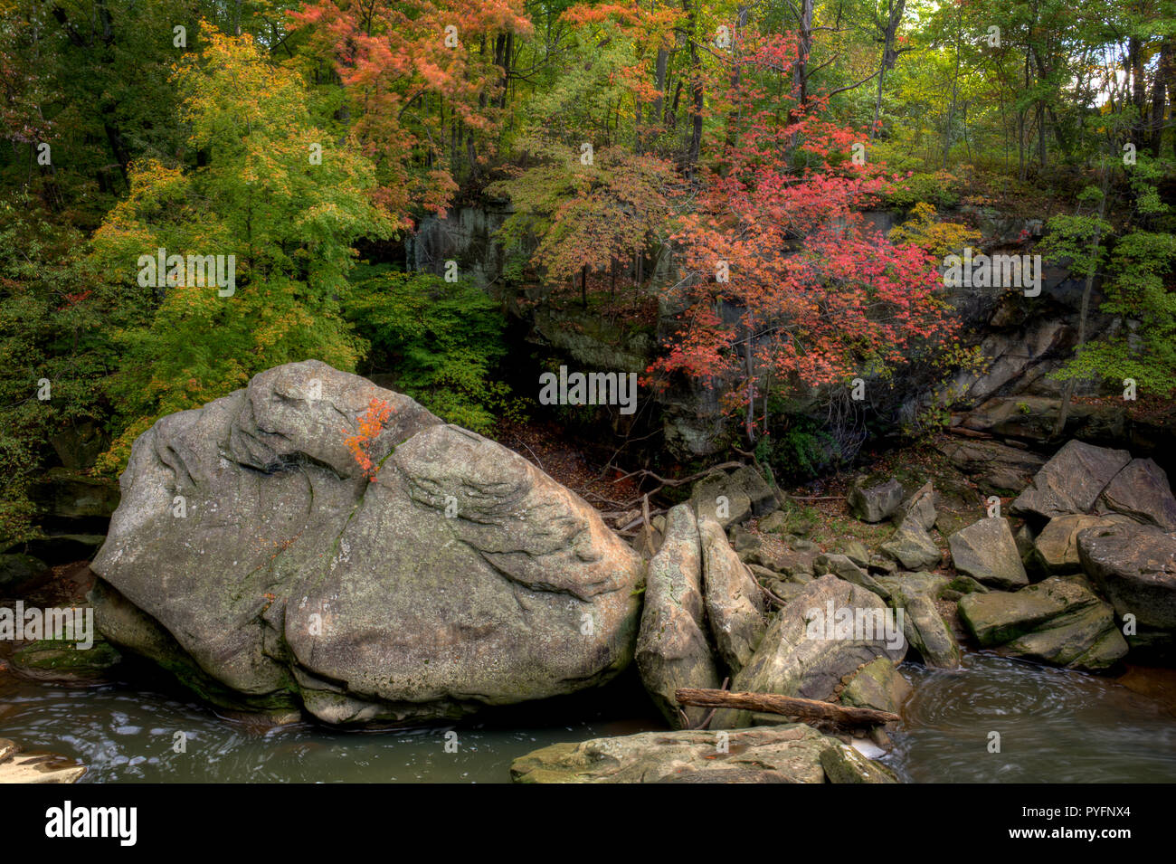 A beautiful autumn scene along the Rocky River in Berea Ohio. Giant sandstone boulders sit in the river giving it its name. Stock Photo