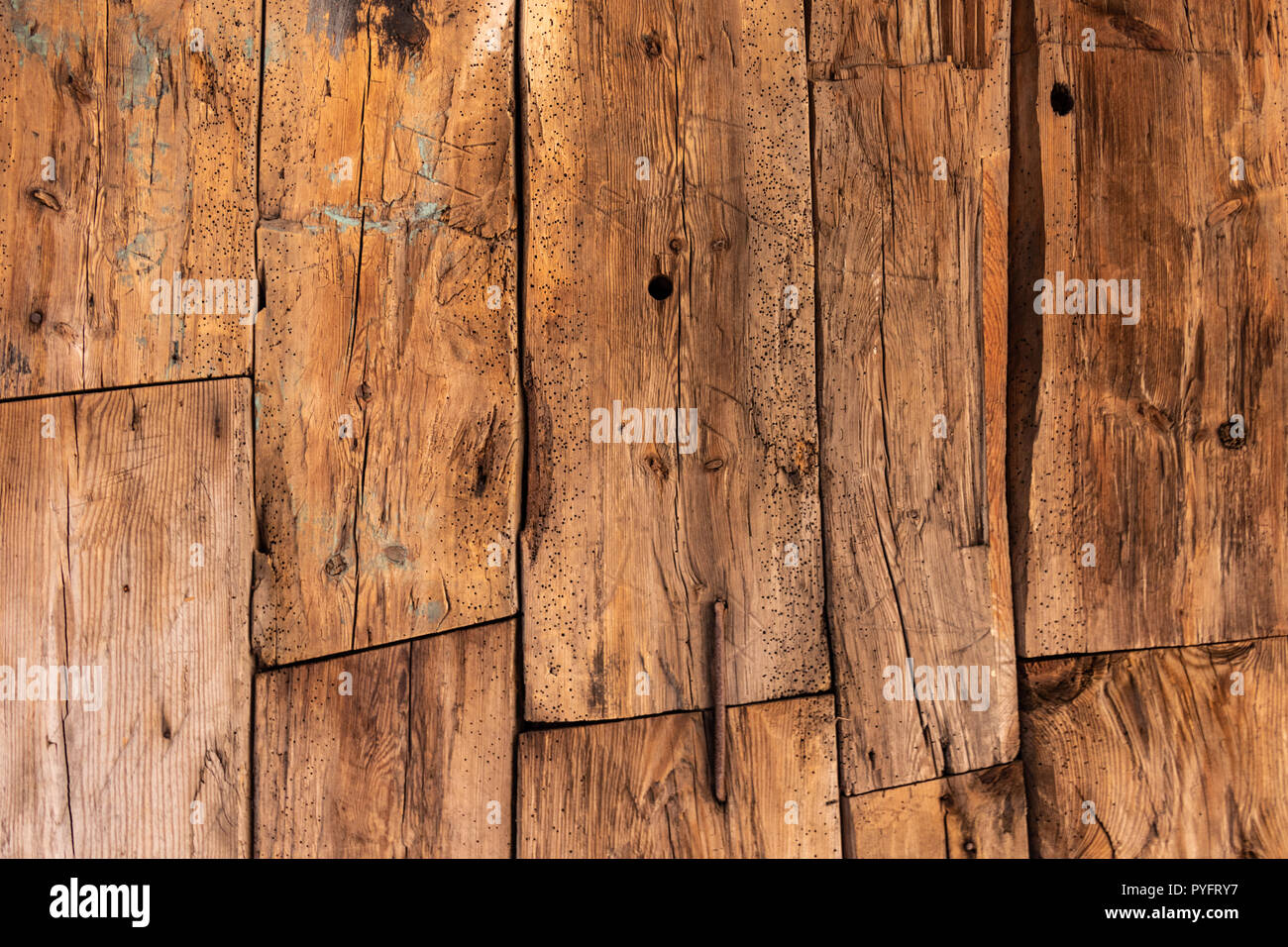Old wooden planks nailed together pattern background. Visible wear and