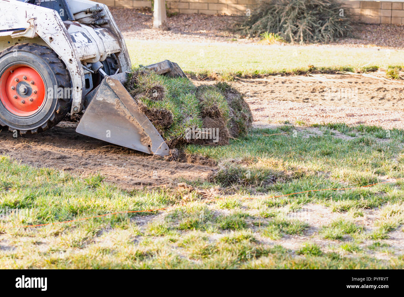Small Bulldozer Removing Grass From Yard Preparing For Pool Installation  Stock Photo - Alamy
