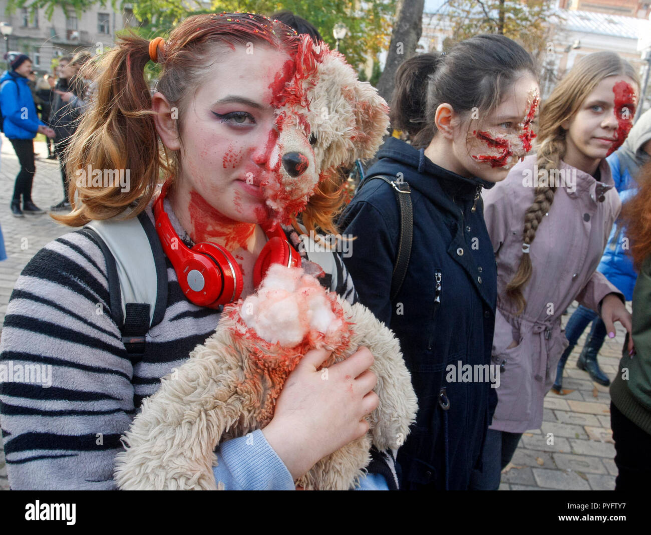 People are seen dressed in zombie costumes and make-up during the celebrations. Hundreds of people marched through the streets in Kiev downtown, on the eve of the Halloween zombie celebrations. Stock Photo