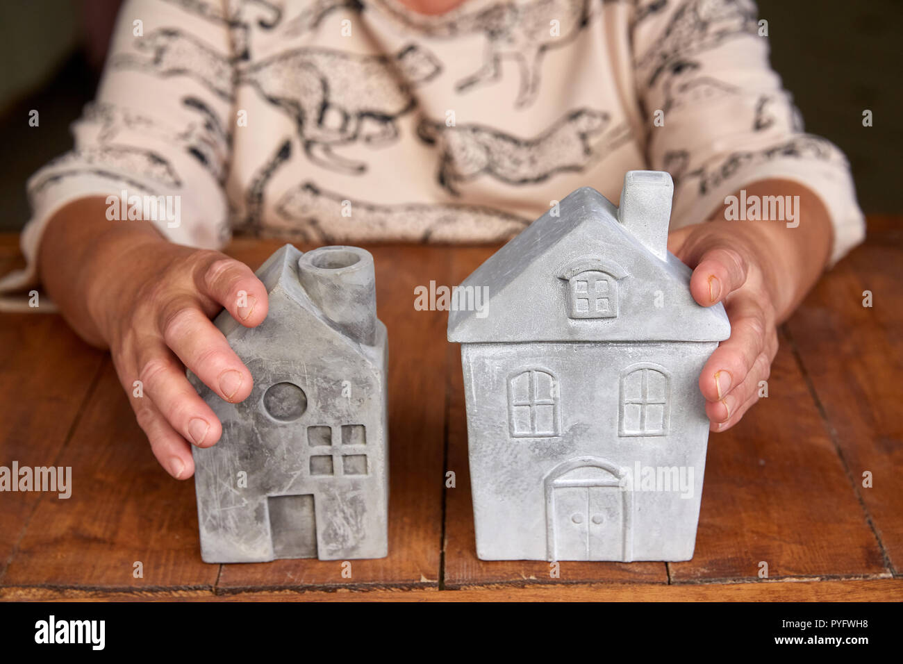 Saving for buy a new house or real estate and loan for plan business investment in the future concept. Senior woman with house model at table Stock Photo