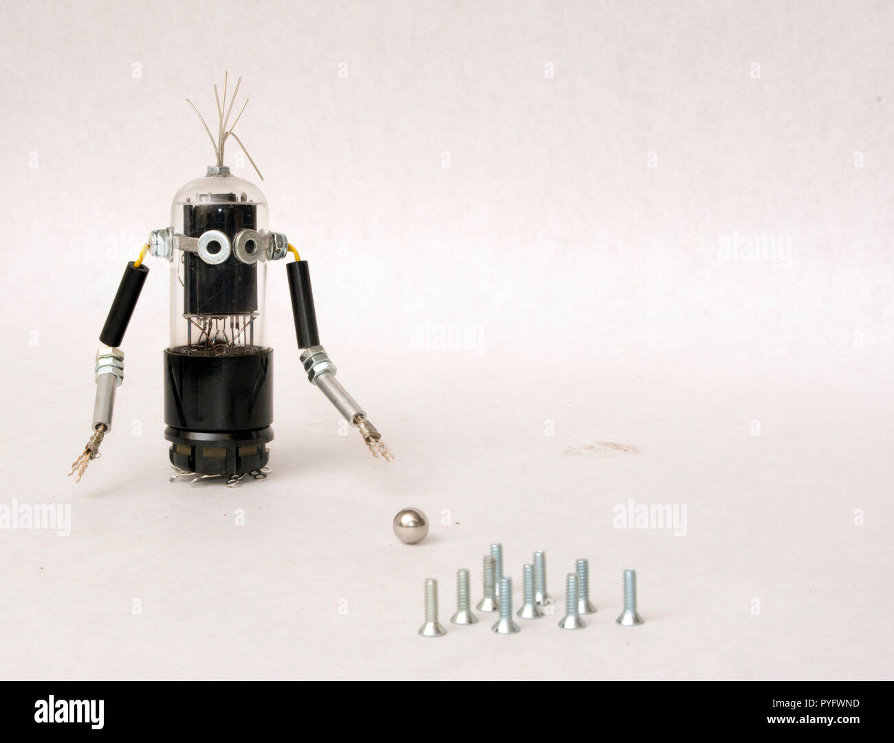 Robot figure bowling with screws Stock Photo