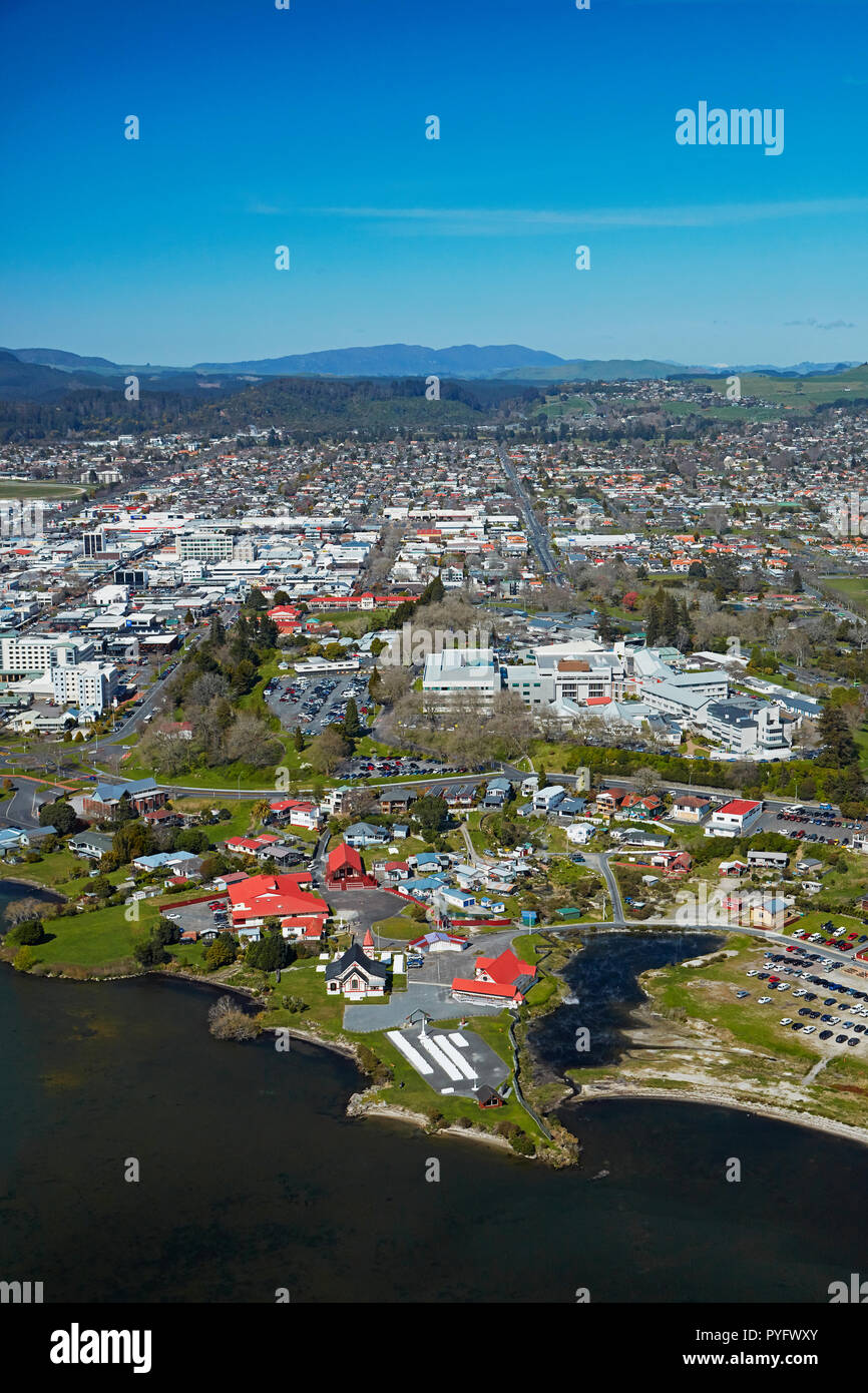 Lake Rotorua, Ohinemutu Maori Village, and city centre, Rotorua, North Island, New Zealand - aerial Stock Photo